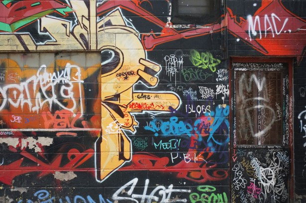 closed door in alley covered with graffiti 