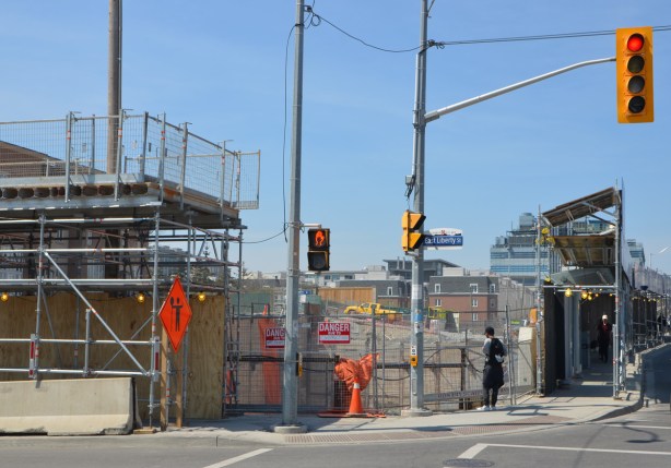 the NW corner of Strachan Ave and East Liberty Street, construction site with fence and hoardings. 