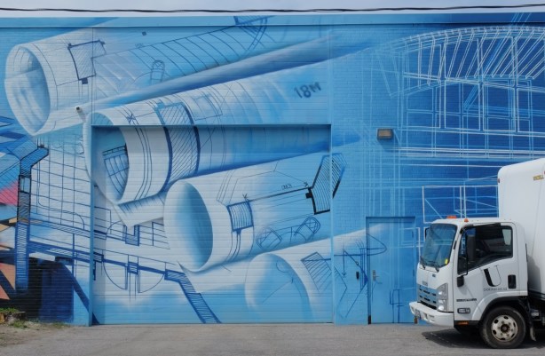 blue mural of blueprints on the side of a building