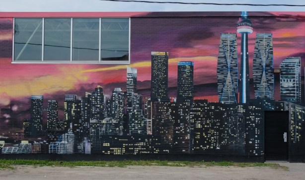 mural of Toronto at night with lots of lights, CN Tower, 