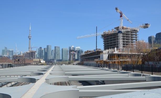looing over the railway tracks to city skyline and CN Tower, construction of new building on the right 