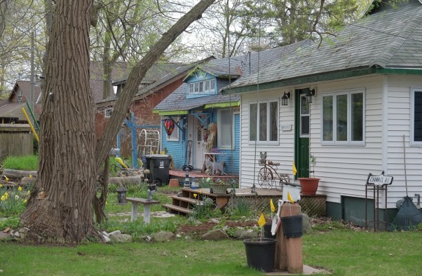 two houses on Wards Island, small wood housses, one bright blue and the other is white 