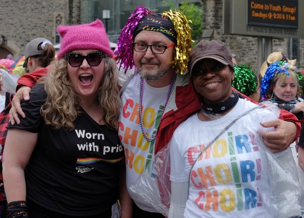 group of three pose for a picture, two are wearing Tshirts that say choir Choir Choir. 