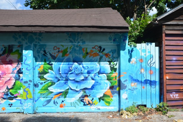 blue flower painted on a garage door, by @chrispperez