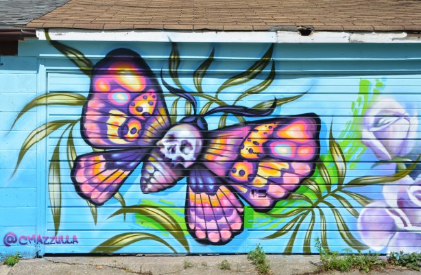 colourful butterfly mural on a garage door, blue background
