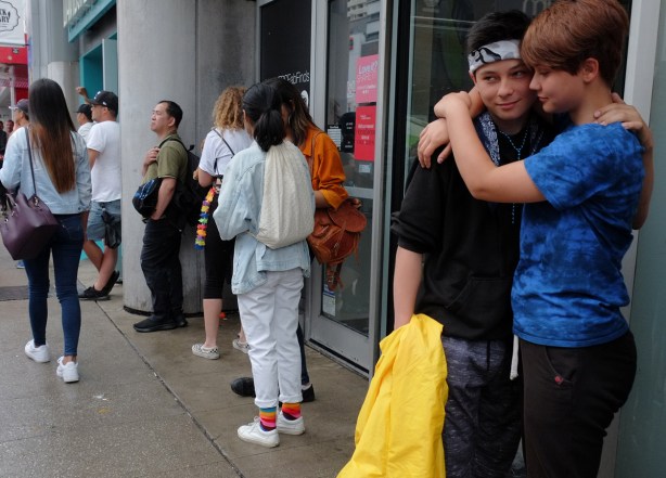 a couple hugging on the sidewalk 