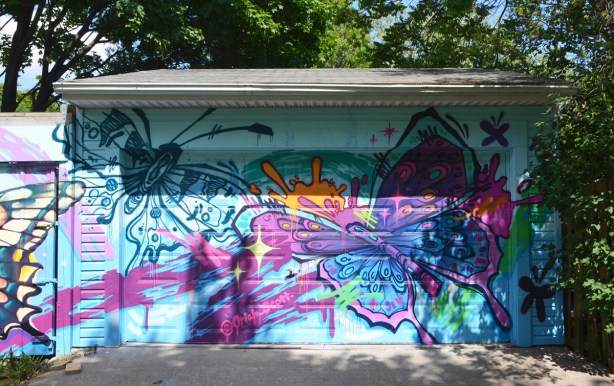 two large butterflies in a mural by @oriah_scott
