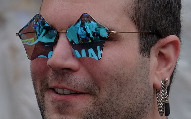 up close shot of man wearing blue star shaped sun glasses 