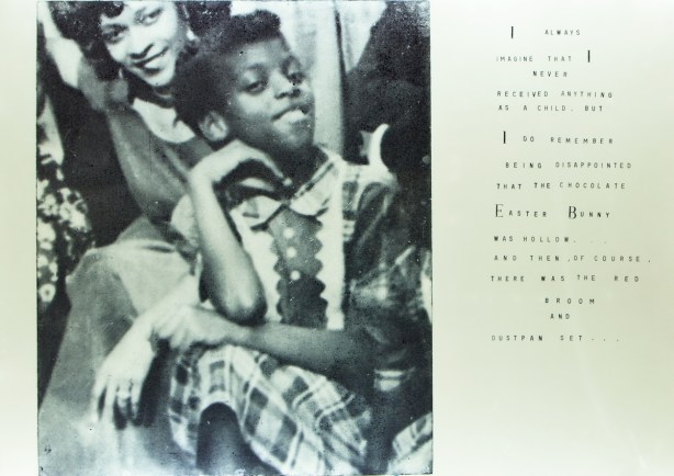 old black and white photo of a black girl, smiling, in dress, with words beside that say "