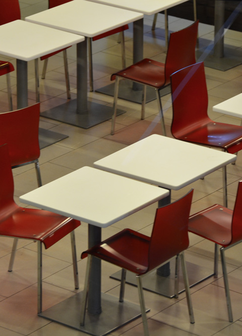 red chairs and white tables in an empty restaurant