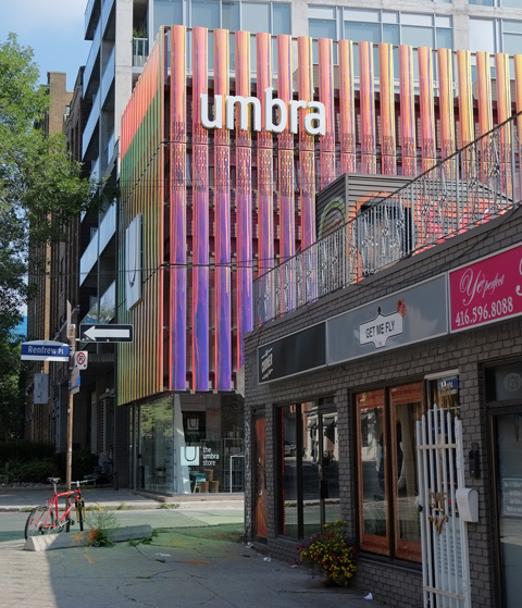 building, umbra store, vertical lines on exterior of a material that changes colour depending on the light