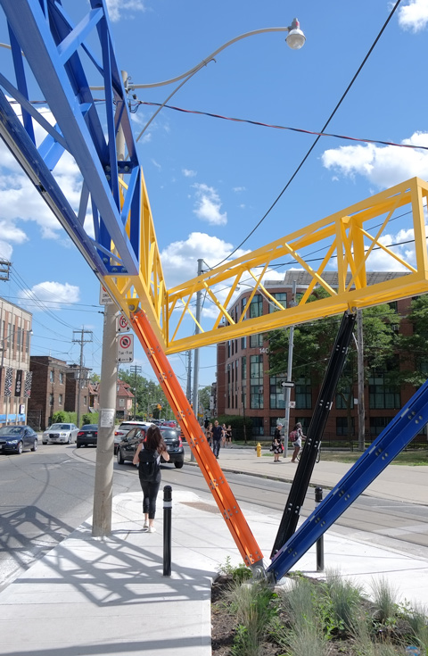 A woman walks past Three Points Where Two Lines meet