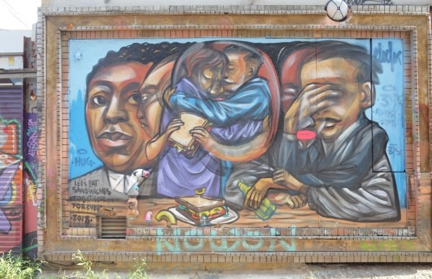 let's eat sandwiches together forever, a mural by elicser, with people and sandwiches, people in the middle are hugging 