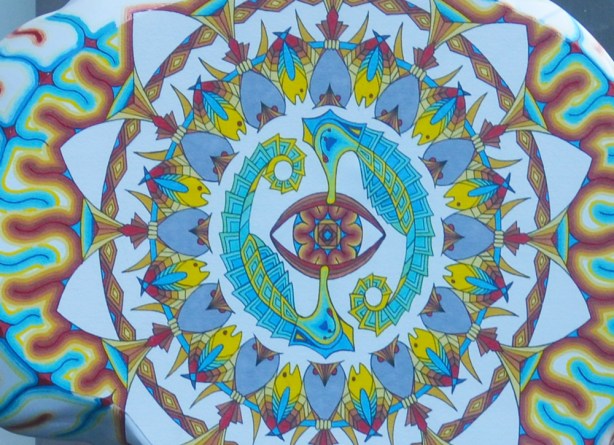 close up of painting on brain shaped sculpture, called Mids Eye by David Bagley, circular pattern of fish and seahorses