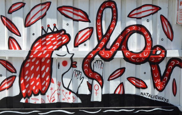 part of a mural by natalieveryb, in red and white, a woman, with long red hair, eyes closed, in black water, with red leaves 