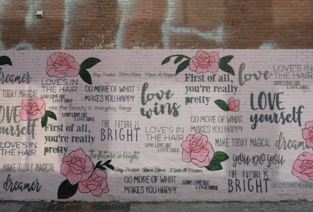 pink roses and words about love on a mural