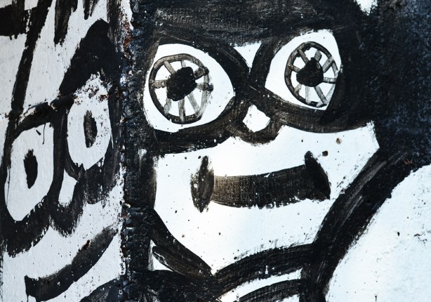 two faces, black line painted on a white background, smiling faces, 