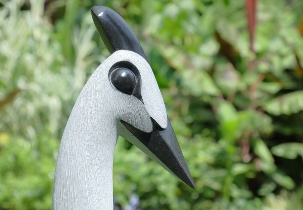 head of a bird carved in black and white stone 