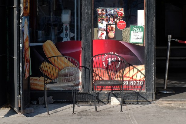 two metal chairs outside a churros place