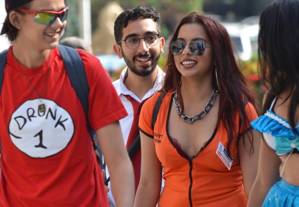 people walking to Fan Expo. Man in a red T-shirt with drunk 1 on it, similar to a Dr. Suess thing 1 t shirt