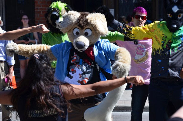 people in life size animal costumes including heads, dance along in a fitness session on Yonge street during Open Streets