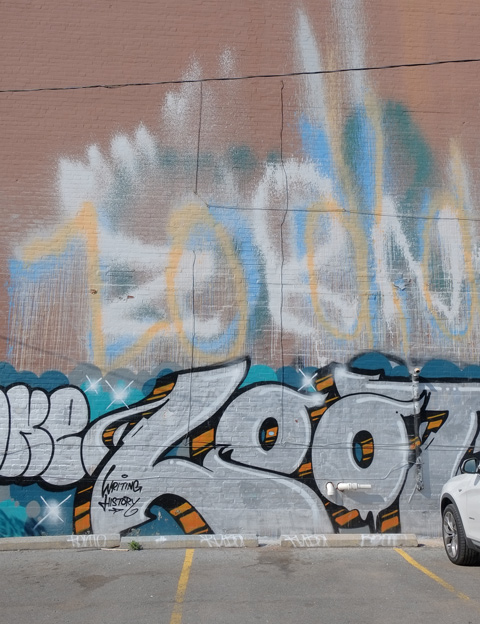 the side of a building covered with graffiti 