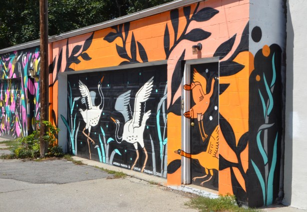 alley mural on a garage, herons and geese, 