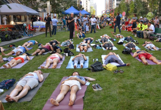 doing yoga on grass laid down on the street, Bloor Street, temporary park for Open Streets