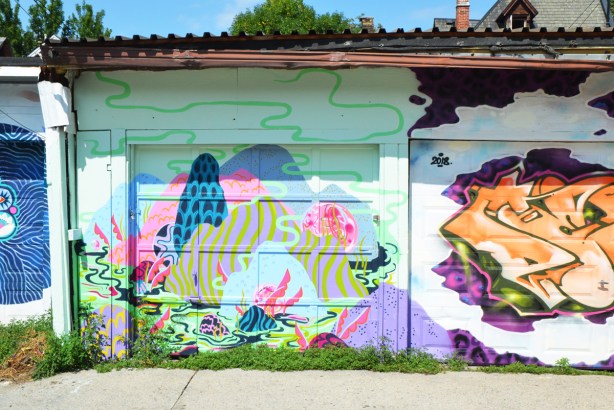 three murals in a lane 