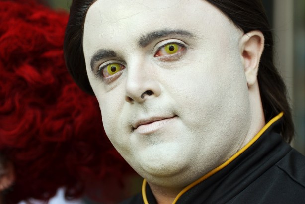 man with shite face and yellowish green eyes