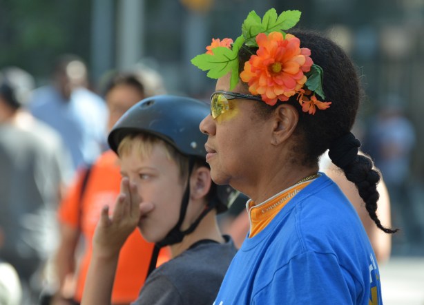 a woman with flowers in hair in profile
