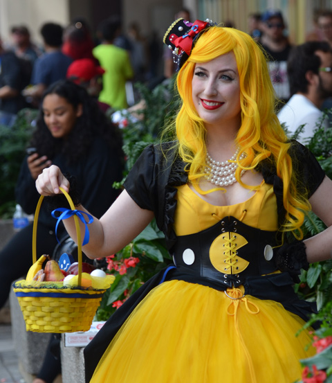 woman in yellow wig, and matching yellow dress, carrying a yellow basket