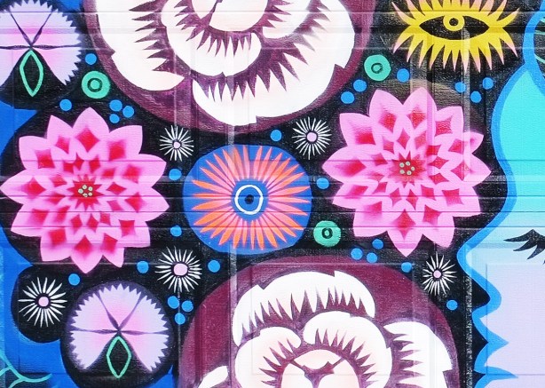 close up of stylized flowers in a mural in pinks and blues