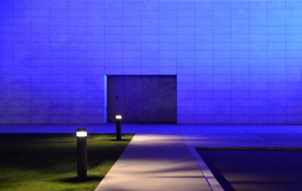 side of the Aga Khan museum lit in bluish purple light