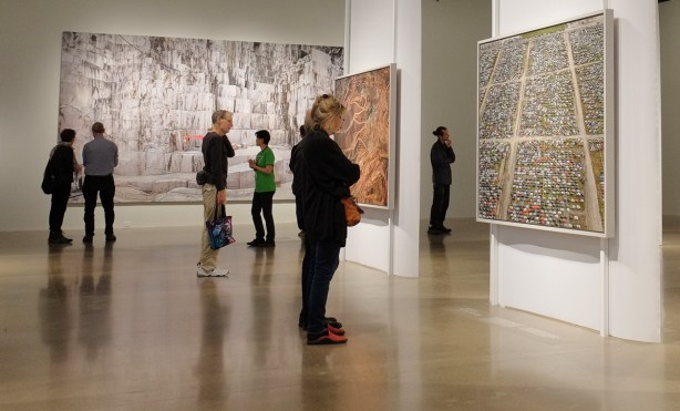 people viewing art exhibit at AGO, photos by Edward Burtynsky 
