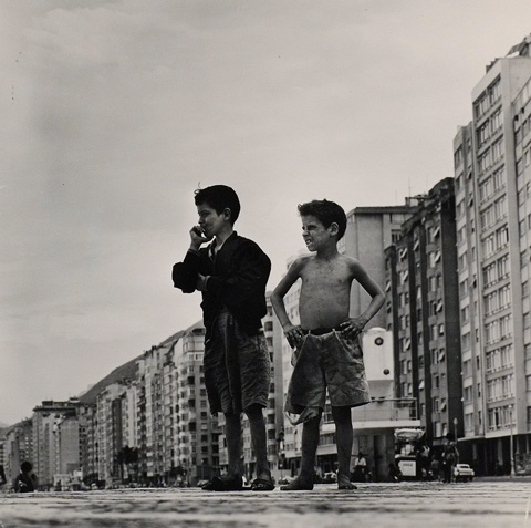 two boys in front of a row of apartment buildings, photo by Gorodn Parks