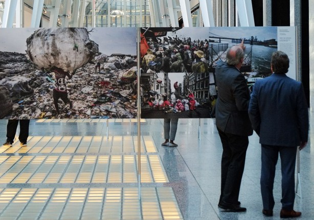 World press photo exhibit at Alan Lambert Galleria, two men looking at one of the photos, one man is pointing to something in that photo 