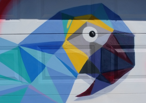 parrot head on a garage door, mural, done in triangles and other straight edged shapes