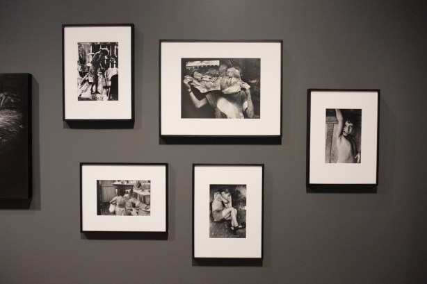 five black and white photos on a dark grey wall, photos by Gordon Parks of poverty in Rio de Janeiro in the 1960s
