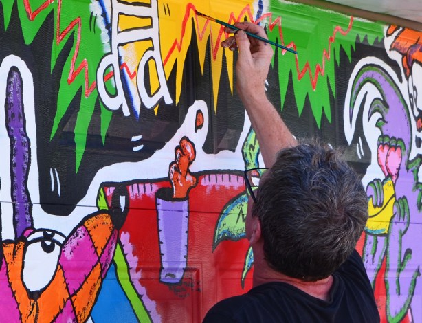 Runt, street artist, painting a mural