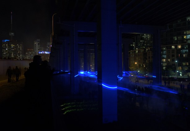 blue lights under the Gardiner at the Bentway, in front of Fort York, a light show called Waterlicht by Dutch artist Daan Roosegaarde