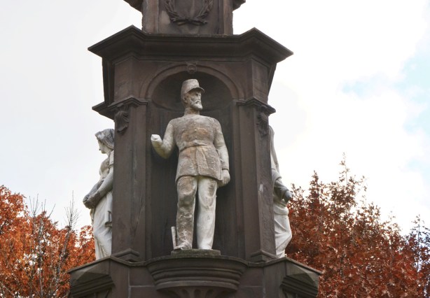 close up of statues on monument - soldier with missing arm, from the 1800s,
