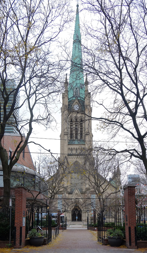 St. James Cathedral and steeple from across the street, shows whole of front of the church, in early winter so the trees in front have no leaves 