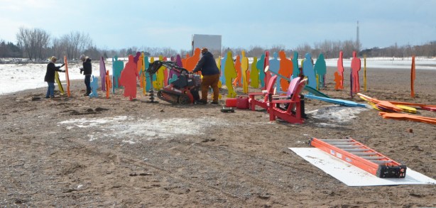 constructing an art installation on the beach in the winter, Woodbine Beach, Winter Stations, colourful life size plywood cutouts of people