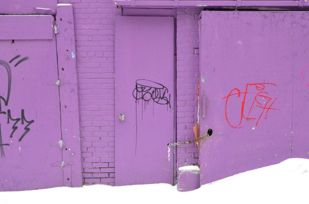 purple garage with purple door, snow in front