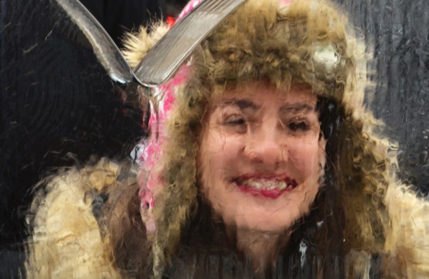 a woman's face as she looks through a block of ice