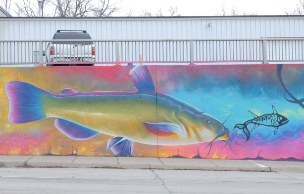 part of a Nick Sweetman mural on 30th street, a yellowish fish with blue fins