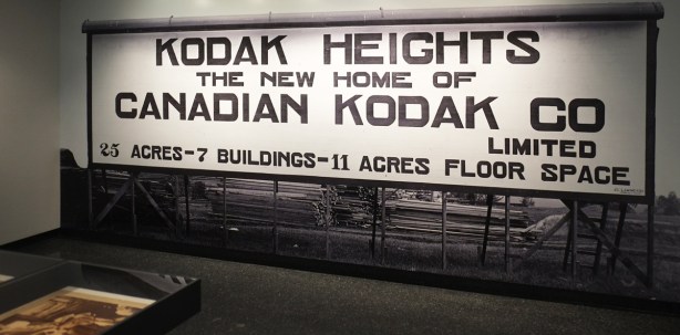 photo of a large billboard advertising the new home of Kodak in Kodak Heights, Keele Street, Toronto, back when it was being built. 