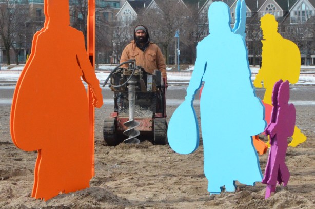 man riding on a small machine that digs holes in the ground 