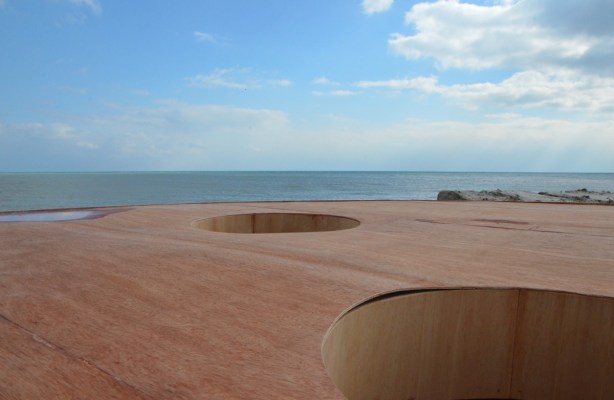 looking out of a hole in the roof of 'Mind Station' art installation, towards Lake Ontario, other circular holes in the roof 
